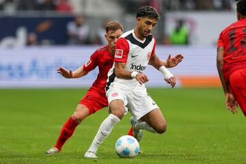 Joshua Kimmich of Munich (L) in action against Omar Marmoush of Frankfurt 
