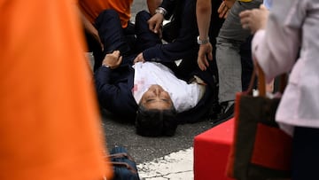 Former Japanese Prime Minister Shinzo Abe lies on the ground after he was shot during an election campaign in Nara, western Japan July 8, 2022 in this photo taken by The Asahi Shimbun. Image pixelated at source. The Asahi Shimbun/via REUTERS ATTENTION EDITORS - THIS IMAGE WAS PROVIDED BY A THIRD PARTY. MANDATORY CREDIT. NO RESALES. NO ARCHIVES. JAPAN OUT. NO COMMERCIAL OR EDITORIAL SALES IN JAPAN.