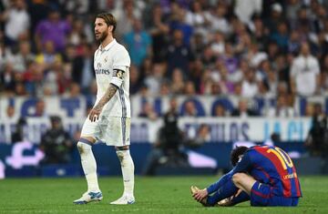 Sergio Ramos of Real Madrid walks past Lionel Messi of Barcelona as he is sent off during the La Liga match between Real Madrid CF and FC Barcelona at Estadio Bernabeu on April 23, 2017 in Madrid, Spain.