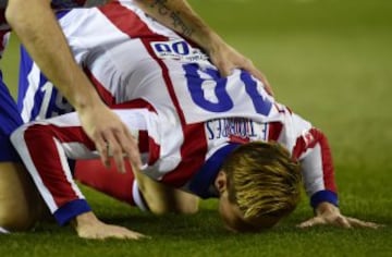 Kissing the turf. One of the best players Atletico Madrid ever produced.