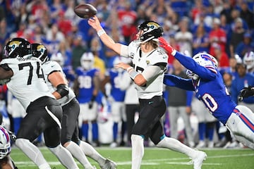 Jacksonville Jaguars quarterback Trevor Lawrence (16) throws a pass under pressure by Buffalo Bills linebacker Von Miller (40) in the fourth quarter at Highmark Stadium. 