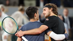Spain's Carlos Alcaraz Garfia (R) speaks with Greece's Stefanos Tsitsipas after winning at the end of their men's singles quarter final match on Court Philippe-Chatrier on day ten of the French Open tennis tournament at the Roland Garros Complex in Paris on June 4, 2024. (Photo by Alain JOCARD / AFP)