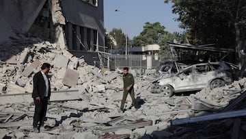 Men walk among debris, after powerful airstrikes shook Damascus on Wednesday, targeting the defense ministry, as Israel vowed to destroy Syrian government forces attacking Druze communities in southern Syria and demanded their withdrawal, in Damascus July 16, 2025. REUTERS/Khalil Ashawi