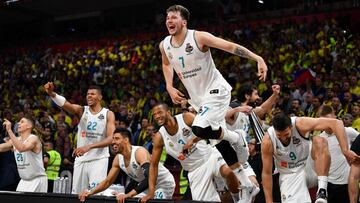 Real Madrid's Slovenian Luka Doncic (C-7) jumps over the barrier as the team celebrates their 85-80 win in the Euroleague Final Four finals basketball match between Real Madrid and Fenerbahce Dogus Istanbul at The Stark Arena in Belgrade on May 20, 2018. / AFP PHOTO / Andrej ISAKOVIC