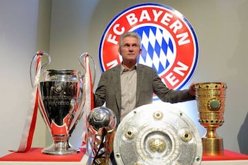 More please | Bayern Munich's head coach Jupp Heynckes posing with the UEFA Champions League, the German Football Cup (DFB-Pokal), the Super Cup and the Bundesliga German League trophies.