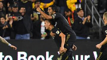 Los Angeles FC midfielder Eduard Atuesta (20) celebrates with forward Carlos Vela (top) after scoring on a goal on a penalty kick against the Seattle Sounders in the first half at Banc of California Stadium