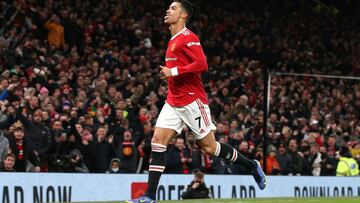 MANCHESTER, ENGLAND - DECEMBER 02:    Cristiano Ronaldo of Manchester United celebrates scoring a goal to make the score 2-1 during the Premier League match between Manchester United and  Arsenal at Old Trafford on December 2, 2021 in Manchester, England.