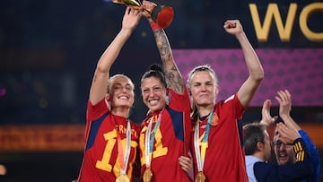 (FILES) Spain's midfielder #10 Jennifer Hermoso, midfielder #11 Alexia Putellas and defender #04 Irene Paredes celebrate with the trophy after winning the Australia and New Zealand 2023 Women's World Cup final football match between Spain and England at Stadium Australia in Sydney on August 20, 2023. Spain's ex-football federation chief Luis Rubiales on February 3, 2025 goes on trial in Madrid over his forcible kiss on the lips of player Jenni Hermoso. The 47-year-old provoked worldwide outrage after he cupped Hermoso's head and gave her an unsolicited kiss during the medal ceremony after Spain won the 2023 Women's World Cup in Australia. (Photo by FRANCK FIFE / AFP)