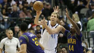 Dallas Mavericks forward Dirk Nowitzki (41), of Germany, passes the ball against New Orleans Pelicans defenders Solomon Hill (44) and Anthony Davis (23) during the first half of an NBA basketball game in Dallas, Saturday, Feb. 25, 2017. (AP Photo/LM Otero)