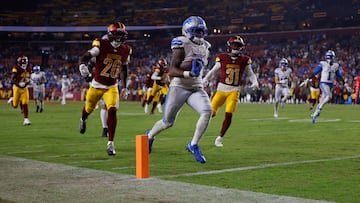 Nov 9, 2025; Landover, Maryland, USA; Detroit Lions running back Jahmyr Gibbs (0) runs in for a touchdown past Washington Commanders safety Quan Martin (20) and cornerback Jonathan Jones (31) during the fourth quarter at Northwest Stadium. Mandatory Credit: Peter Casey-Imagn Images