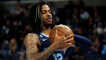 Jan 1, 2023; Memphis, Tennessee, USA; Memphis Grizzlies guard Ja Morant (12) checks the ball before the game against the Sacramento Kings at FedExForum. Mandatory Credit: Petre Thomas-USA TODAY Sports