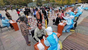 Health workers take swabs from residents to be tested for the COVID-19 coronavirus as part of a mass testing program following a new outbreak of the coronavirus in Qingdao, in China&#039;s eastern Shandong province on October 13, 2020. (Photo by STR / AFP