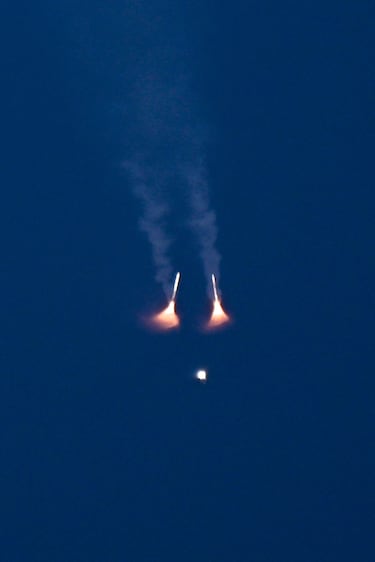 El cohete Space Launch System (SLS) que transportaba la cápsula tripulada Artemis II Orion de la NASA asciende tras el despegue, con sus propulsores de combustible sólido ya separados.