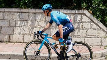 Team Astana's Colombian rider Miguel Angel Lopez holds his leg as he rides in the first kilometers of the 4th stage of the Giro d'Italia 2022 cycling race, 172 kilometers between Avola and Etna-Nicolosi, Sicily, on May 10, 2022. (Photo by Luca Bettini / AFP) (Photo by LUCA BETTINI/AFP via Getty Images)