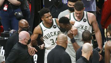 Jun 29, 2021; Atlanta, Georgia, USA; Milwaukee Bucks forward Giannis Antetokounmpo (34) is helped off the court with an injury against the Atlanta Hawks in the third quarter during game four of the Eastern Conference Finals for the 2021 NBA Playoffs at State Farm Arena. Mandatory Credit: Brett Davis-USA TODAY Sports