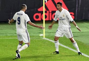 Cristiano Ronaldo celebrates his third goal with teammate Karim Benzema in the FIFA Club World Cup 2016 final.