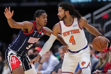 HOUSTON, TEXAS - DECEMBER 16: Derrick Rose #4 of the New York Knicks controls the ball against Josh Christopher #9 of the Houston Rockets during the first half at Toyota Center on December 16, 2021 in Houston, Texas.