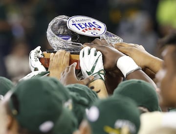 HOUSTON, TX - DECEMBER 27: Baylor Bears hoist the championship trophy as they defeat the Vanderbilt Commodores 48-35 during the Academy Sports + Outdoors Texas Bowl at NRG Stadium on December 27, 2018 in Houston, Texas.
