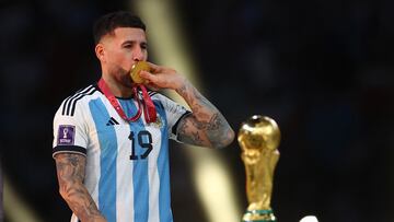 Soccer Football - FIFA World Cup Qatar 2022 - Final - Argentina v France - Lusail Stadium, Lusail, Qatar - December 18, 2022 Argentina's Nicolas Otamendi kisses his medal during the trophy ceremony REUTERS/Kai Pfaffenbach