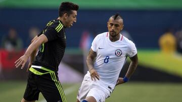 El jugaor de la seleccion mexicana Hector Herrera, izquierda, disputa el balon con Arturo Vidal