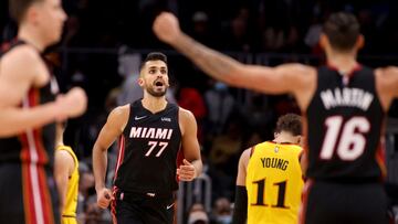 Jan 12, 2022; Atlanta, Georgia, USA; Miami Heat center Omer Yurtseven (77) reacts after a basket with forward Caleb Martin (16) during the fourth quarter against the Atlanta Hawks at State Farm Arena. Mandatory Credit: Jason Getz-USA TODAY Sports