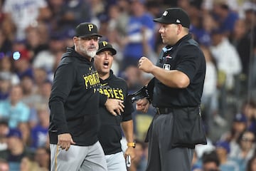 Hitting coach Andy Haines #49 of the Pittsburgh Pirates reacts to a strike out call from the home plate umpire during the seventh inning of a game against the Los Angeles Dodgers