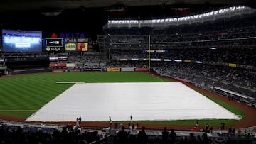 NEW YORK, NEW YORK - OCTOBER 17: A tarp covers the infield during a rain delay prior to game five of the American League Division Series between the Cleveland Guardians and New York Yankees at Yankee Stadium on October 17, 2022 in New York, New York.   Al Bello/Getty Images/AFP