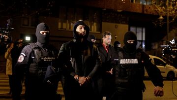 Andrew Tate and Tristan Tate are escorted by police officers outside the headquarters of the Directorate for Investigating Organized Crime and Terrorism in Bucharest (DIICOT) after being detained for 24 hours, in Bucharest, Romania, December 29, 2022. Inquam Photos/Octav Ganea via REUTERS ATTENTION EDITORS - THIS IMAGE WAS PROVIDED BY A THIRD PARTY. ROMANIA OUT. NO COMMERCIAL OR EDITORIAL SALES IN ROMANIA TPX IMAGES OF THE DAY
