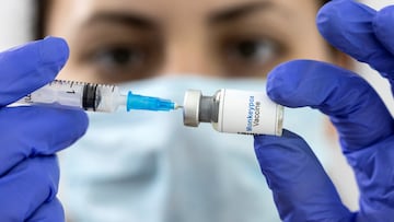 A woman holds a mock-up vial labeled "Monkeypox vaccine" and medical syringe in this illustration taken, May 25, 2022.