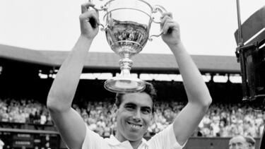 Manuel Santana lifts the trophy after his victory over Dennis Ralston Championship in Wimbledon, England, on July 1, 1966. (Photo by S&G/PA Images via Getty Images)
