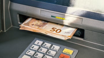 ATM and cash money. Euros withdrawal from an ATM machine, closeup view