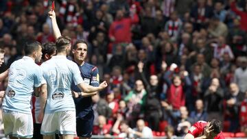 El defensa argentino del Celta de Vigo, Gustavo Cabral, es expulsado por el &aacute;rbitro Estrada Fern&aacute;ndez tras pisar al delantero del Athletic de Bilbao, Aritz Aduriz.