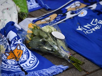 Hand-written messages are attached to bunches of flowers on a growing pile of tributes outside Leicester City Football Club's King Power Stadium