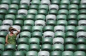 Una espectadora viendo la final de dobles femenino sola en un sector soleada de la grada.