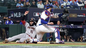 Emmanuel Rivera #15 of the Arizona Diamondbacks slides into home plate to score a run past Jonah Heim #28 of the Texas Rangers