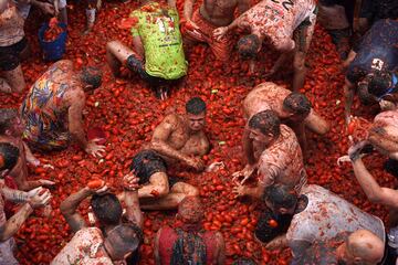 La localidad valenciana ha vuelto a albergar su mítica fiesta donde miles de personas han protagonizado una 'batalla campal' a base de lanzamientos de tomates.