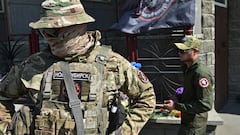 Fighters of Wagner private mercenary group visit at a makeshift memorial with portraits of Russian mercenary chief Yevgeny Prigozhin and Wagner group commander Dmitry Utkin outside the local office of the Wagner private mercenary group in Novosibirsk, Russia August 24, 2023. REUTERS/Stringer