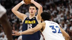 Apr 23, 2023; Minneapolis, Minnesota, USA; Denver Nuggets center Nikola Jokic (15) looks to pass while Minnesota Timberwolves center Karl-Anthony Towns (32) defends during the second quarter of game four of the 2023 NBA Playoffs at Target Center. Mandatory Credit: Matt Krohn-USA TODAY Sports