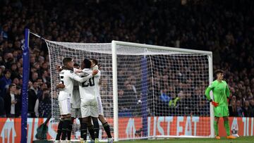 Real Madrid's Brazilian striker Rodrygo Goes is mobbed by teammates after scoring the team's second goal during the Champions League quarter-final second-leg football match between Chelsea and Real Madrid at Stamford Bridge in London on April 18, 2023. (Photo by ADRIAN DENNIS / AFP)