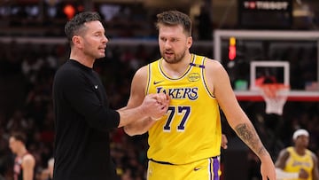 CHICAGO, ILLINOIS - MARCH 27: Head coach JJ Redick of the Los Angeles Lakers high fives Luka Doncic #77 against the Chicago Bulls during the second half at the United Center on March 27, 2025 in Chicago, Illinois. NOTE TO USER: User expressly acknowledges and agrees that, by downloading and or using this photograph, User is consenting to the terms and conditions of the Getty Images License Agreement. Michael Reaves/Getty Images/AFP (Photo by Michael Reaves / GETTY IMAGES NORTH AMERICA / Getty Images via AFP)