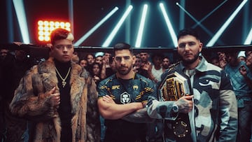 Los cantantes SAIKO (izquierda) y Omar Montes, con el campe車n del peso pluma de la UFC Ilia Topuria en el centro.