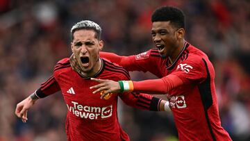 Manchester United's Brazilian midfielder #21 Antony (L) celebrates with Manchester United's Ivorian midfielder #16 Amad Diallo (R) after scoring their second goal during the English FA Cup Quarter Final football match between Manchester United and Liverpool at Old Trafford in Manchester, north west England, on March 17, 2024. (Photo by Paul ELLIS / AFP) / RESTRICTED TO EDITORIAL USE. No use with unauthorized audio, video, data, fixture lists, club/league logos or 'live' services. Online in-match use limited to 120 images. An additional 40 images may be used in extra time. No video emulation. Social media in-match use limited to 120 images. An additional 40 images may be used in extra time. No use in betting publications, games or single club/league/player publications. / 