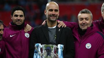LONDON, ENGLAND - FEBRUARY 25: Pep Guardiola the head coach / manager of Manchester City celebrates with the trophy and assistants Mikel Arteta and Domenec Torren after winning the Carabao Cup Final between Arsenal and Manchester City at Wembley Stadium o