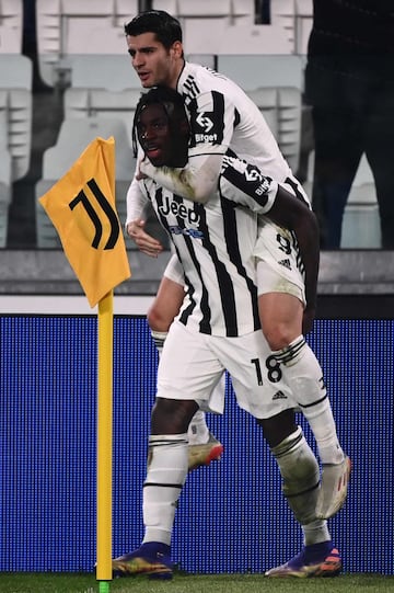 Moise Kean carries Juventus forward Alvaro Morata as he celebrates after opening the scoring during the Italian Serie A football match between Juventus and Cagliari on December 21 at the Juventus stadium in Turin. (Photo by Marco BERTORELLO / AFP)
