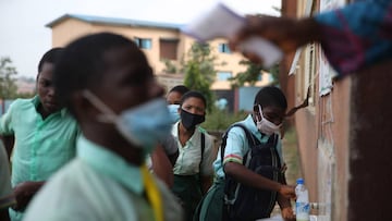 Babs Fafunwa Millennium Senior Secondary students wash their hands in a basin as they resume to write the West African Examination Council (WAEC) examination in Ojodu district in Lagos, Nigeria. 