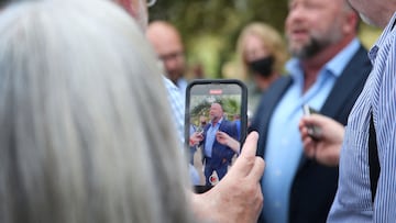 Alex Jones steps outside of the Travis County Courthouse, to do interviews with media after he was questioned under oath.