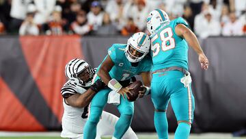 CINCINNATI, OHIO - SEPTEMBER 29: Quarterback Tua Tagovailoa #1 of the Miami Dolphins is sacked by defensive tackle Josh Tupou #68 of the Cincinnati Bengals during the 2nd quarter of the game against the Cincinnati Bengals at Paycor Stadium on September 29, 2022 in Cincinnati, Ohio. Andy Lyons/Getty Images/AFP