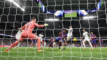 Real Madrid's English midfielder #5 Jude Bellingham (3rdR) challenges Barcelona's German goalkeeper #01 Marc-Andre ter Stegen during the Spanish league football match between Real Madrid CF and FC Barcelona at the Santiago Bernabeu stadium in Madrid on April 21, 2024. (Photo by Thomas COEX / AFP)