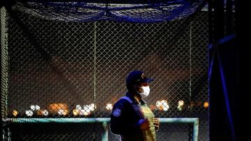 A police officer stands guard as doses of China's Sinopharm vaccines against the coronavirus disease (COVID-19) arrive at the airport, in Lima, Peru February 7, 2021. REUTERS/Angela Ponce NO RESALES. NO ARCHIVES