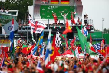MONZA, ITALY - SEPTEMBER 04: Sebastian Vettel of Germany and Ferrari and Nico Rosberg of Germany and Mercedes GP celebrate on the podium during the Formula One Grand Prix of Italy at Autodromo di Monza on September 4, 2016 in Monza, Italy.